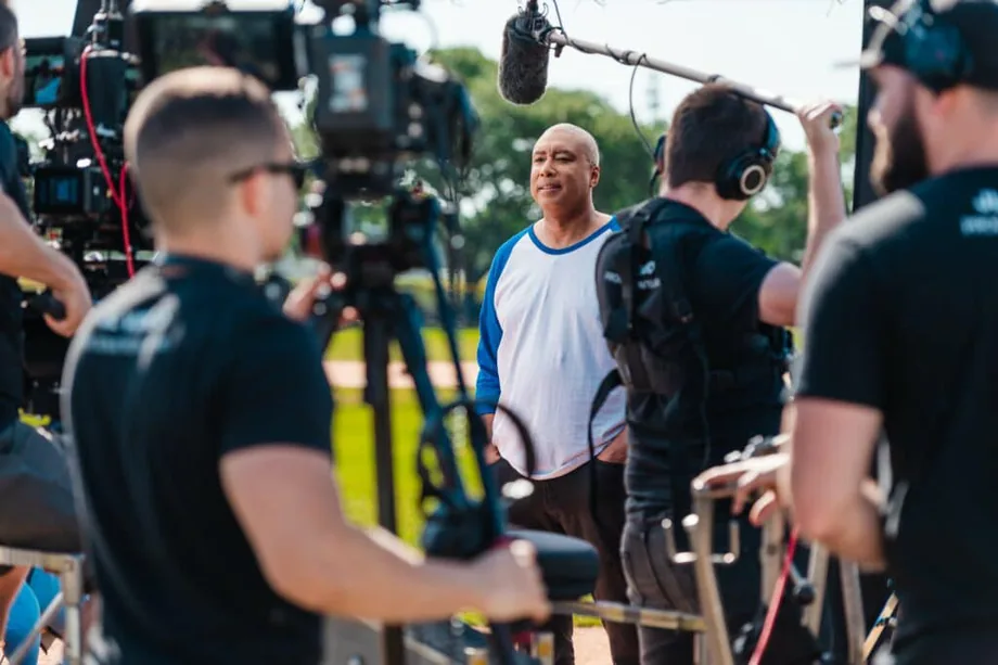 Jordan Lung’s crew filming an outdoor client interview with a cinema camera and boom microphone